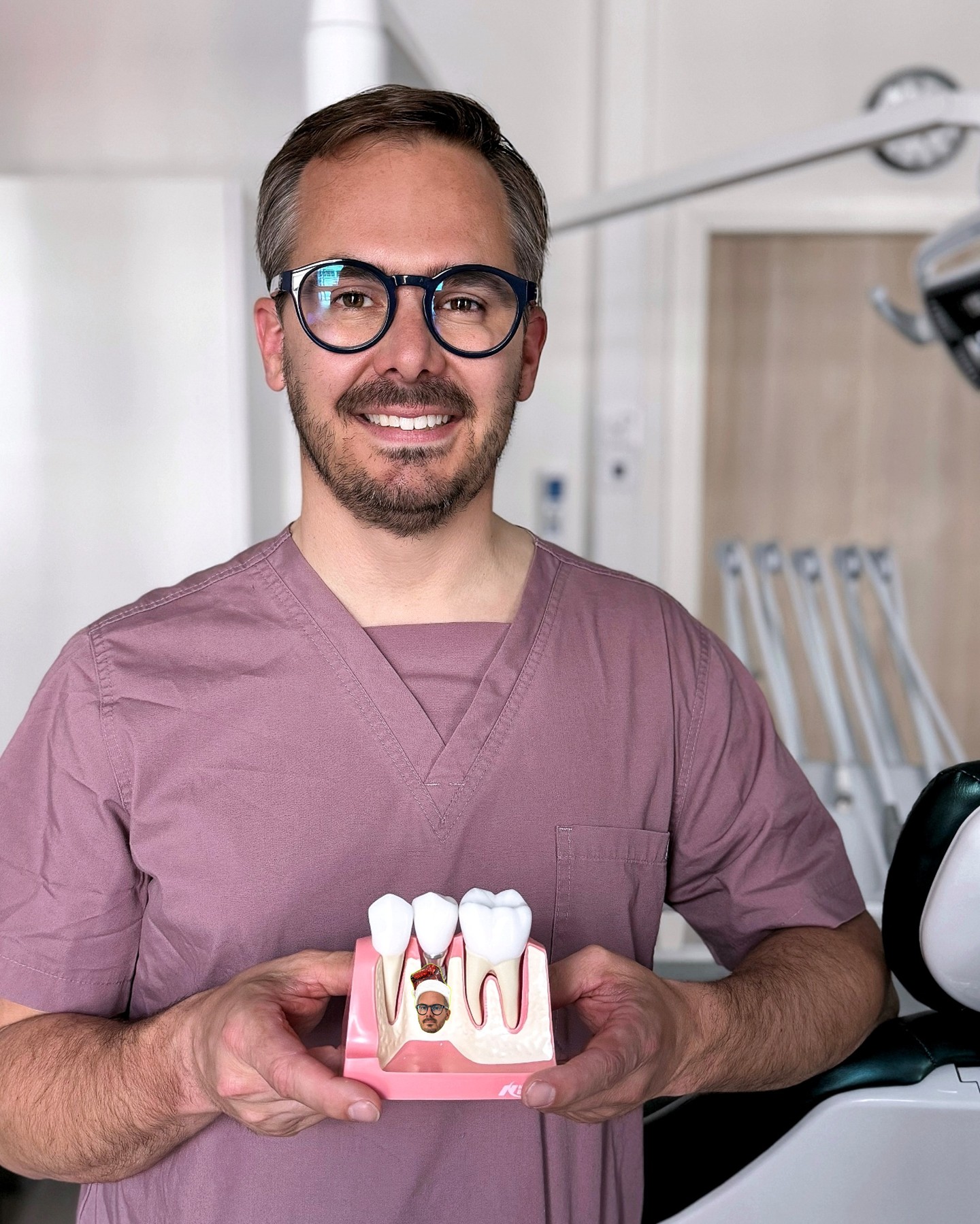 Ville Männistö, a specialist dentist in oral and maxillofacial surgery, demonstrates the structure of a dental implant at his clinic in Tampere.